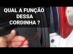 Qual a função dessa cordinha no porta malas