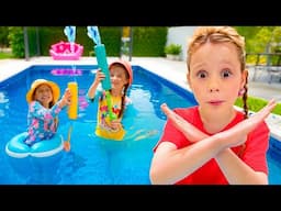 Le père de Nastya montre aux enfants les règles de sécurité de la piscine