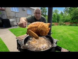 Chicken Fried in Sizzling Oil in a Cauldron over an Open Fire