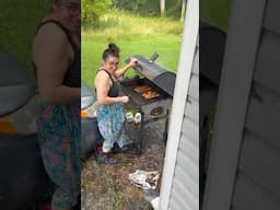 Wife cooking on the Grill in a STORM