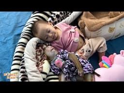 Monkey Kaka and Diem lie together playing on the blanket happily.