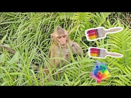 Funny baby monkey Nahu fumbles with a paint brush