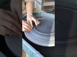 Trimming a dinner plate made with black clay #ceramics #pottery #studioceramics