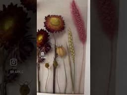 Take a simple frame, a piece of canvas, and a few dried flowers and you have beautiful wall art!