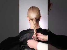 A beautifully unique twisted and braided bun—elegant and full of charm. Credits: @nadigerber.beauty
