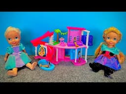 Elsa and Anna toddlers play with the dream house