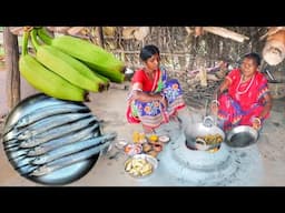 Santali tribe women cooking middle fish curry with raw banana and mango chatni for there lunch