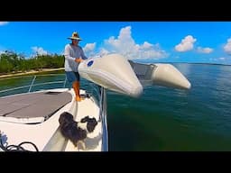 Wrestling a Dinghy on an Antares 11