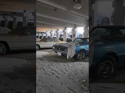 abandoned parking garage full of classic vehicles