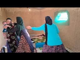 Azita preparing food and Ali going to get sand and cement for the house.