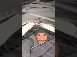 Car camping in a blizzard by a mountain lake in New Zealand.