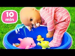 Baby Annabell doll plays with water toys for kids, toy sea creatures & colorful cups in the water.