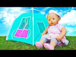 Baby Annabell doll goes camping with a new toy tent for dolls and has fun outdoors.