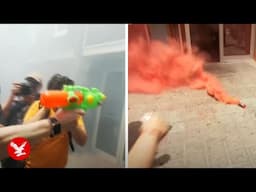 Anti-tourism protesters confront hotel workers with flares and water pistols in Barcelona