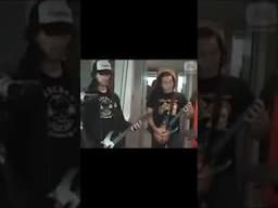 Herman Li and Sam Totman try playing Guitar Hero