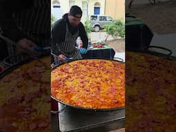 Cooking Spanish Paella of Chorizo and Seafood. London Street Food