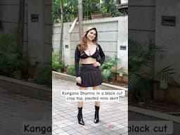 #kanganasharma wears black cut crop top, pleated mini skirt, black boots, and a shoulder bag