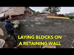 Laying blocks on a retaining wall