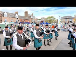 Dunnottar Pipes & Drums opening march through crowd at 2025 Stonehaven Feein' market in Scotland